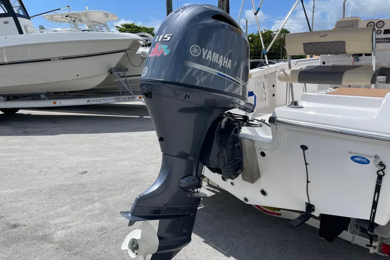 Slide: The Image of 2022 Tidewater 198 CC Adventure with Yamaha 115 outboard motor in a marina setting. - 5
