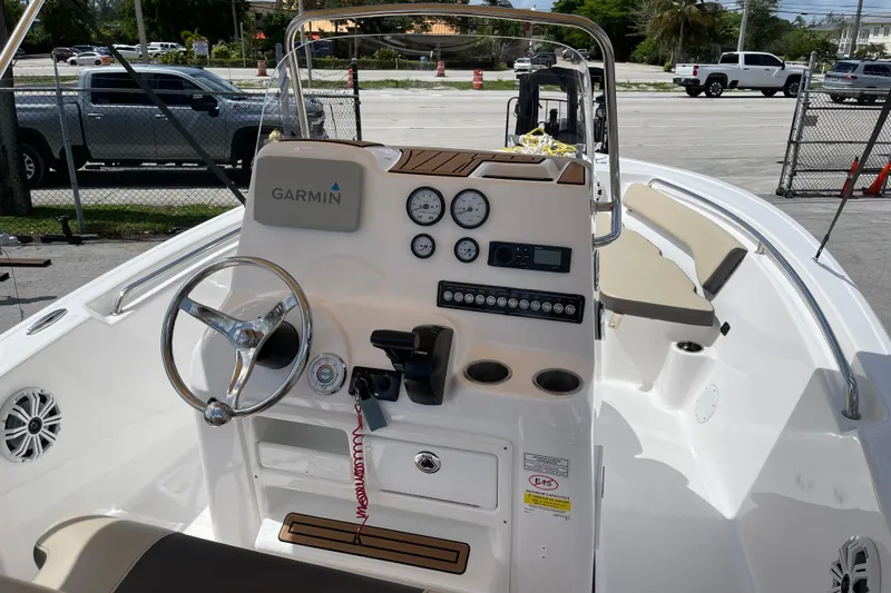 Slide: The Image of 2022 Tidewater 198 CC Adventure boat dashboard with Garmin navigation system and steering wheel. - 7