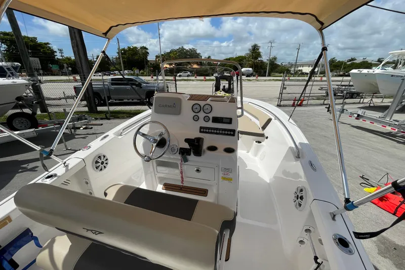 Slide: The Image of 2022 Tidewater 198 CC Adventure boat interior with steering wheel and Garmin navigation system. - 9