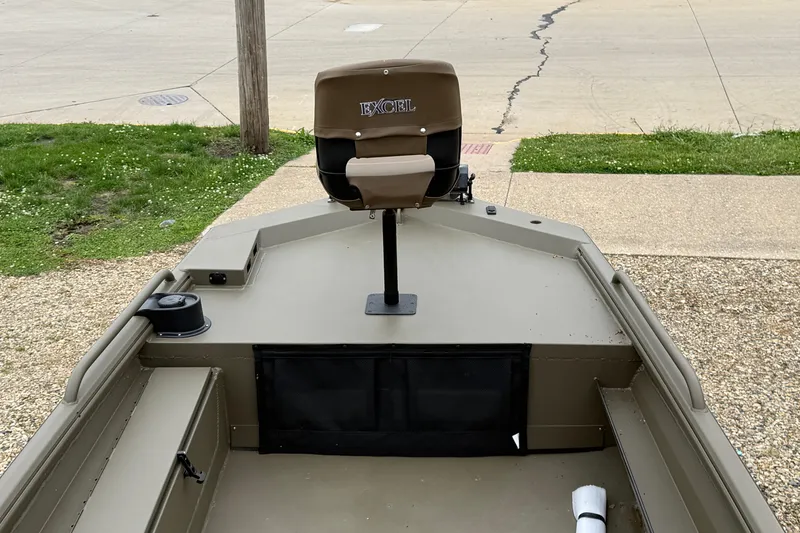 Slide: The Image of 2026 Excel 1860 Shallow Water F4 boat with elevated seat, parked on gravel. - 14