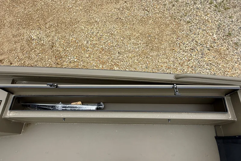 Slide: The Image of Storage compartment of 2026 Excel 1860 Shallow Water F4 boat, open with contents visible. - 15