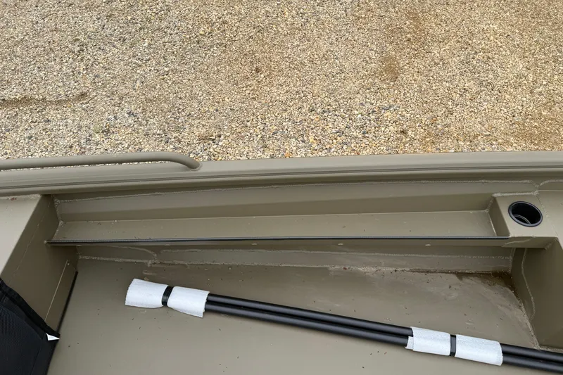 Slide: The Image of Interior view of 2026 Excel 1860 Shallow Water F4 boat, showcasing storage and rod holder. - 16