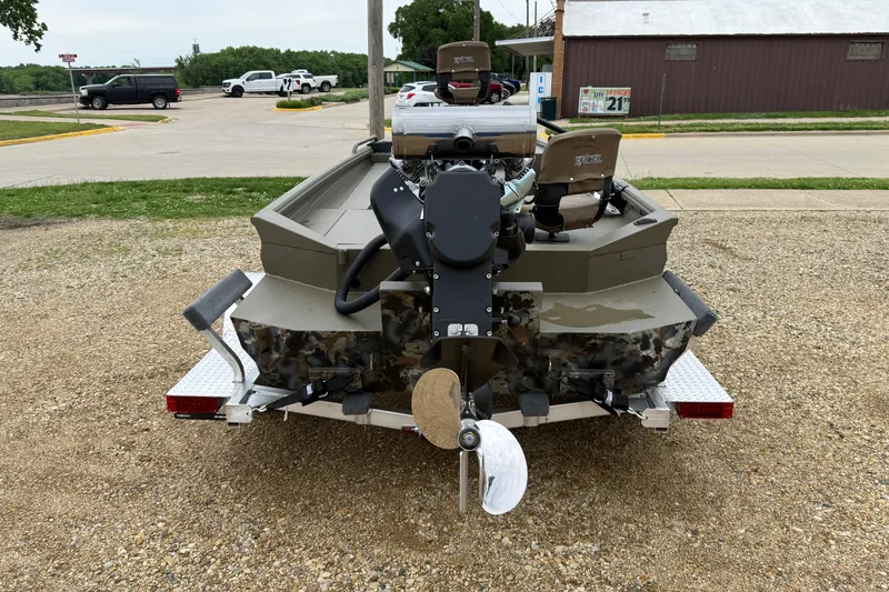 Slide: The Image of 2026 Excel 1860 Shallow Water F4 boat on trailer, rear view, parked outdoors. - 6