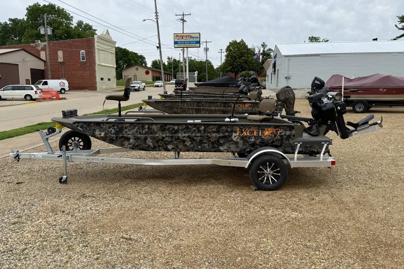 Slide: The Image of 2026 Excel 1860 Shallow Water F4 boat on trailer, parked in a lot. - 8