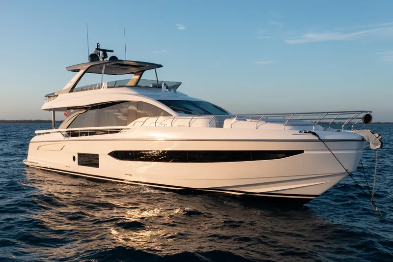 Slide: The Image of Luxury 2022 Azimut 78 yacht on calm ocean waters at sunset. - 1