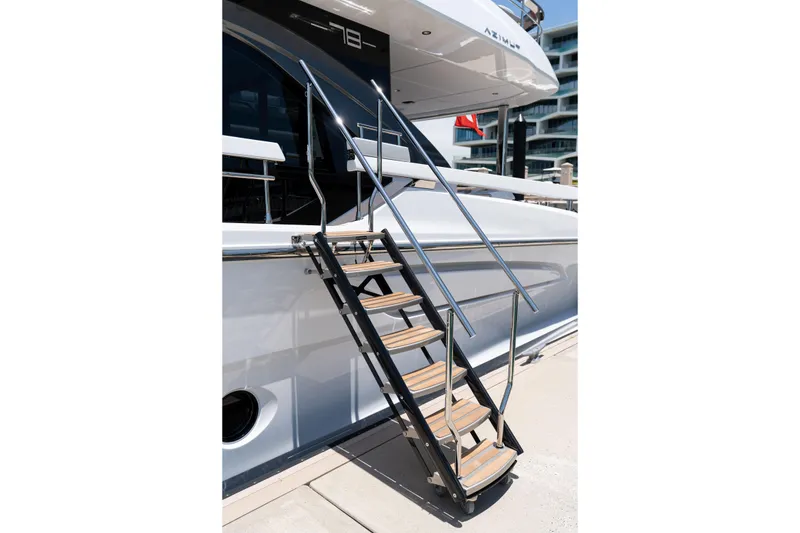 Slide: The Image of Staircase leading to a luxurious 2022 Azimut 78 yacht, docked at a marina. - 20