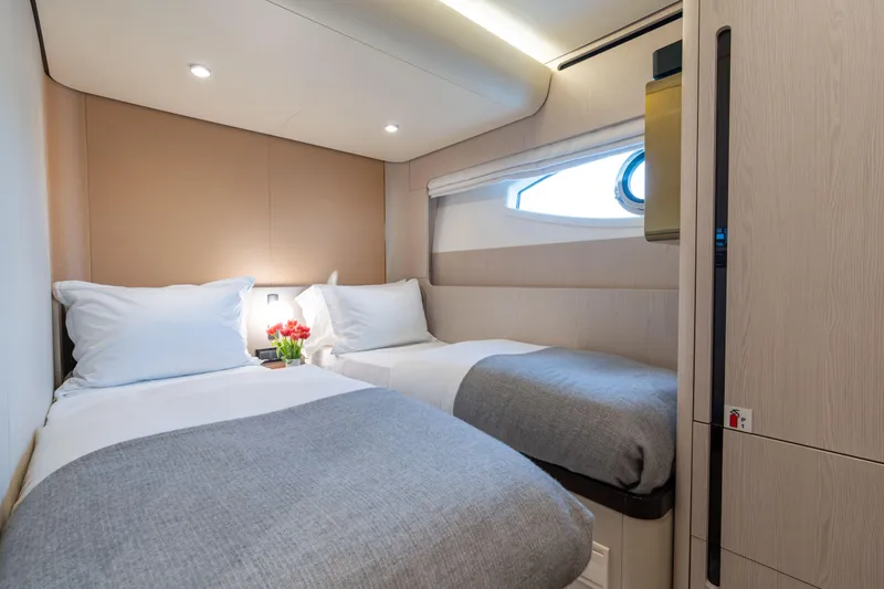 Slide: The Image of Luxurious twin cabin interior on 2022 Azimut 78 yacht, featuring modern design and cozy bedding. - 45