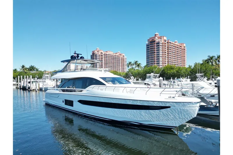 Slide: The Image of 2022 Azimut Fly 78 yacht docked in marina with luxury buildings in background. - 53