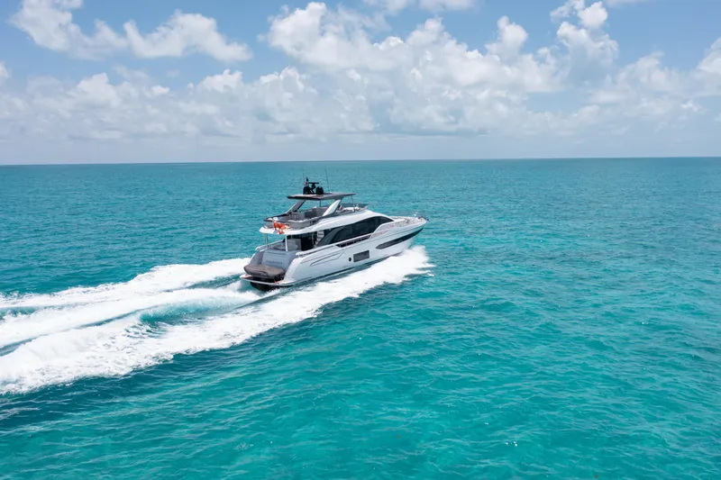 Slide: The Image of Luxury 2022 Azimut 78 yacht cruising on turquoise ocean under clear sky. - 8