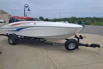 The Image of 2023 Tahoe T18 boat on trailer, parked outdoors on concrete surface. - 1