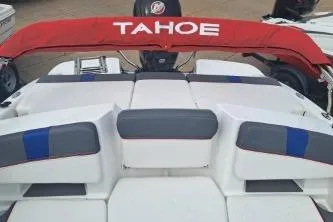 Slide: The Image of 2023 Tahoe T18 boat with red canopy and cushioned seating. - 10
