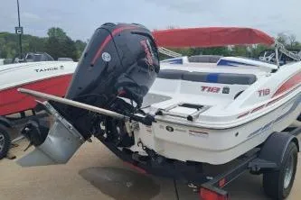 Slide: The Image of 2023 Tahoe T18 boat with outboard motor on trailer, featuring red and white design. - 4