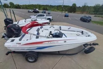 Slide: The Image of 2023 Tahoe T18 boat on trailer in parking lot, featuring sleek design and modern features. - 5