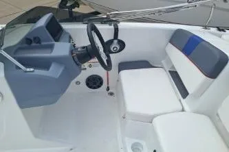 Slide: The Image of 2023 Tahoe T18 boat interior with steering wheel and seating area. - 6
