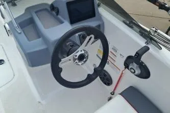 Slide: The Image of 2023 Tahoe T18 boat dashboard with steering wheel and control panel. - 7