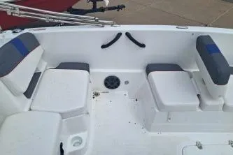 Slide: The Image of 2023 Tahoe T18 boat interior with cushioned seating and storage compartments. - 9