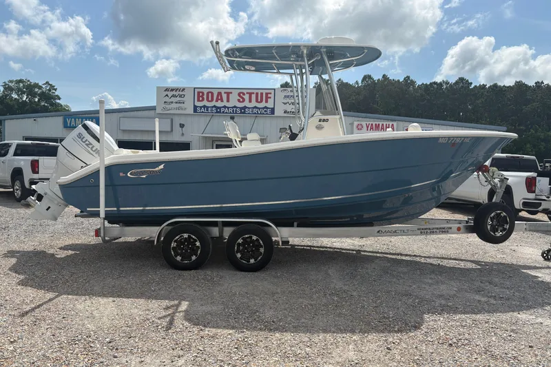 The Image of 2024 Bulls Bay 230 Center Console boat on trailer at dealership, featuring Suzuki engine. - 1