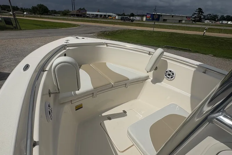 Slide: The Image of 2024 Bulls Bay 230 Center Console boat interior with cushioned seating and speakers. - 17