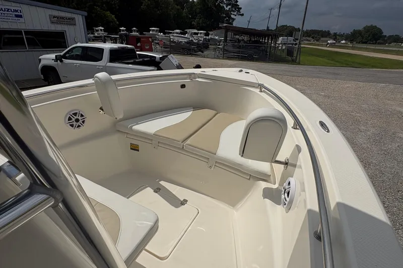 Slide: The Image of 2024 Bulls Bay 230 Center Console boat interior with cushioned seating and speakers. - 18