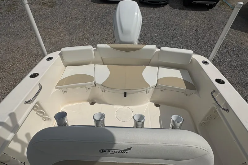 Slide: The Image of 2024 Bulls Bay 230 Center Console boat interior with seating and rod holders. - 19