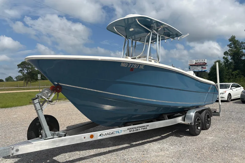 Slide: The Image of 2024 Bulls Bay 230 Center Console boat on trailer, parked outdoors under cloudy sky. - 4