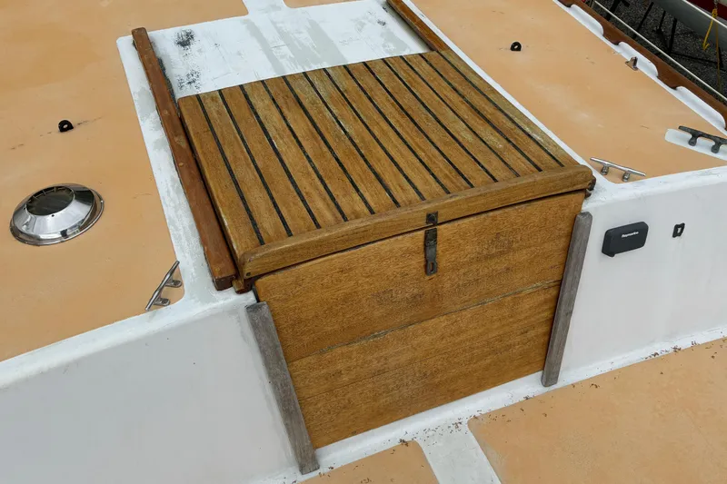 Slide: The Image of Wooden hatch on 1979 Downeast DE38 boat deck, featuring teak slats and metal latch. - 10