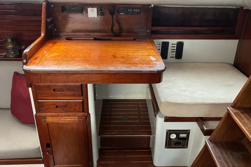 Slide: The Image of 1979 Downeast DE38 interior with wooden desk, navigation equipment, and seating area. - 16