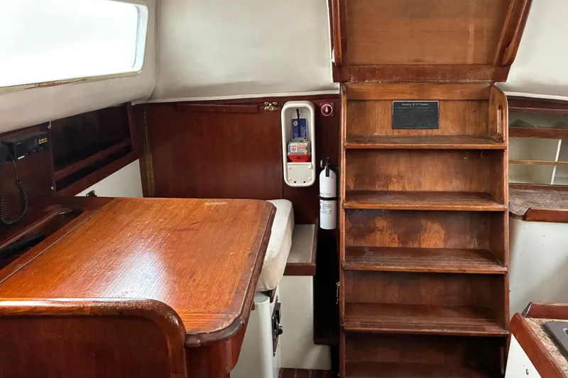 Slide: The Image of Interior of 1979 Downeast DE38 sailboat with wooden table and stairs. - 18