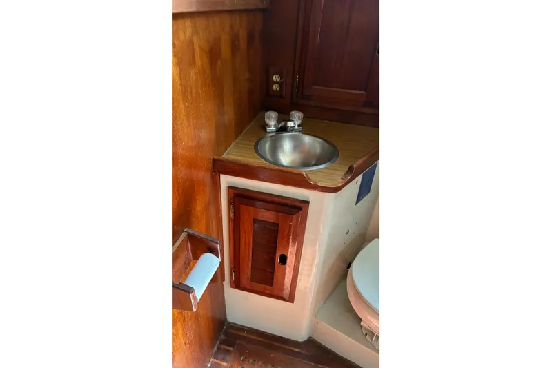 Slide: The Image of 1979 Downeast DE38 boat bathroom with wooden cabinetry and stainless steel sink. - 23