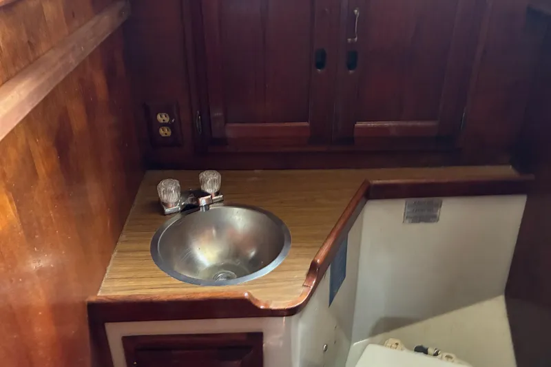Slide: The Image of 1979 Downeast DE38 boat interior with wooden cabinetry and stainless steel sink. - 24