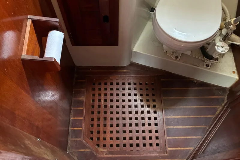 Slide: The Image of 1979 Downeast DE38 boat bathroom with wooden flooring and marine toilet. - 25