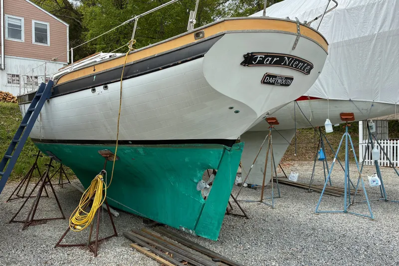 Slide: The Image of 1979 Downeast DE38 sailboat on stands, undergoing maintenance in a boatyard. - 6