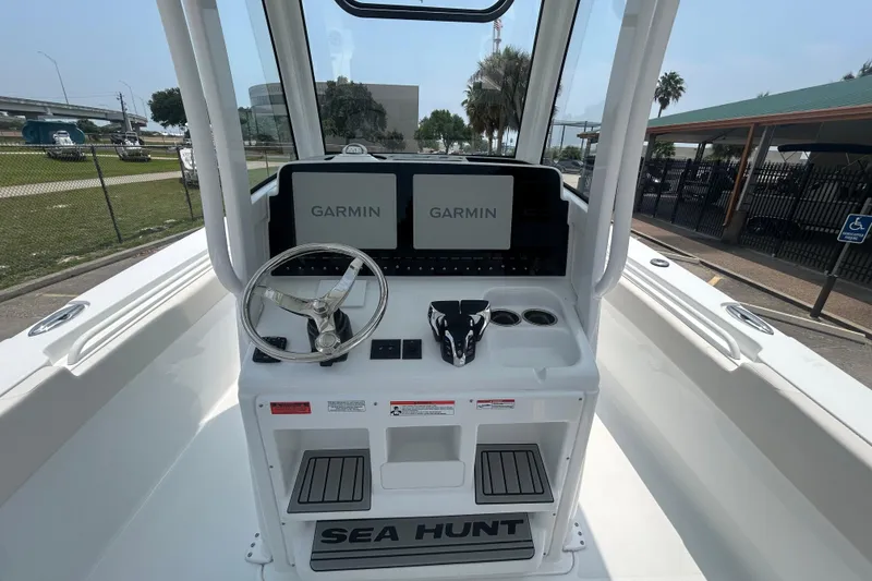 Slide: The Image of 2026 Sea Hunt Gamefish 27 Coffin Box boat helm with Garmin displays and steering wheel. - 11