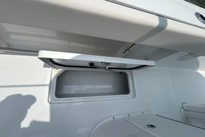 Slide: The Image of 2026 Sea Hunt Gamefish 27 Coffin Box interior storage compartment, open lid view. - 20