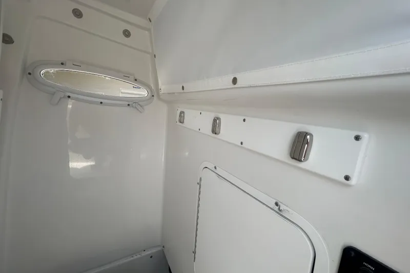 Slide: The Image of Interior view of 2026 Sea Hunt Gamefish 27 Coffin Box, featuring sleek white paneling. - 23