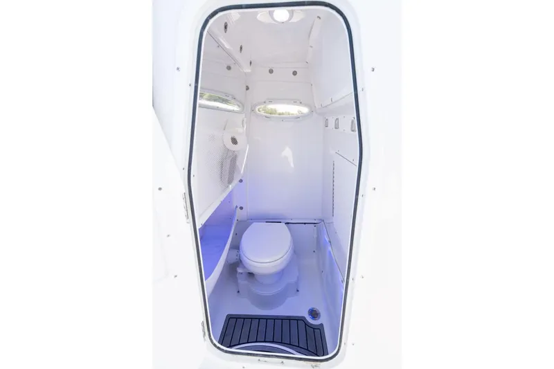 Slide: The Image of Manufacturer Provided Image: 2026 Sea Hunt Gamefish 27 Coffin Box boat interior with compact marine toilet. - 25