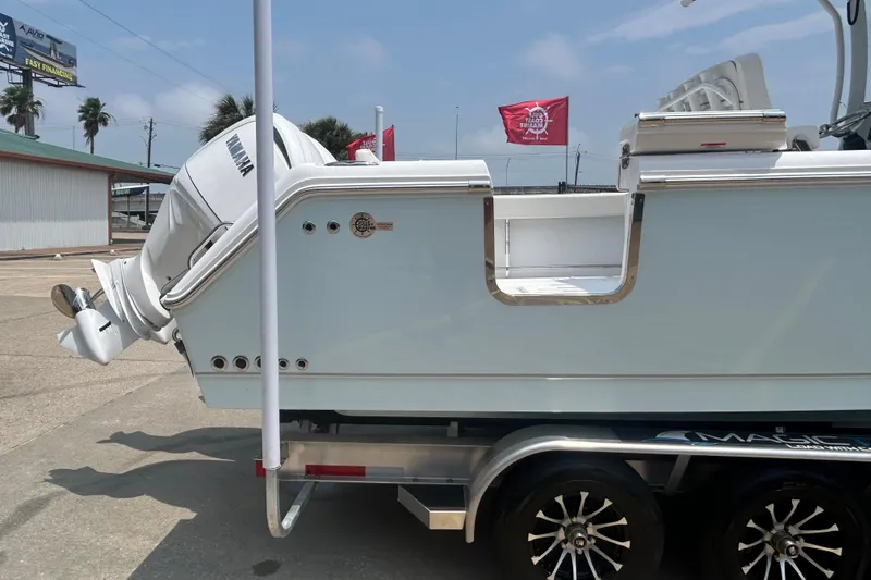 Slide: The Image of 2026 Sea Hunt Gamefish 27 Coffin Box boat on trailer, featuring Yamaha outboard motor. - 3