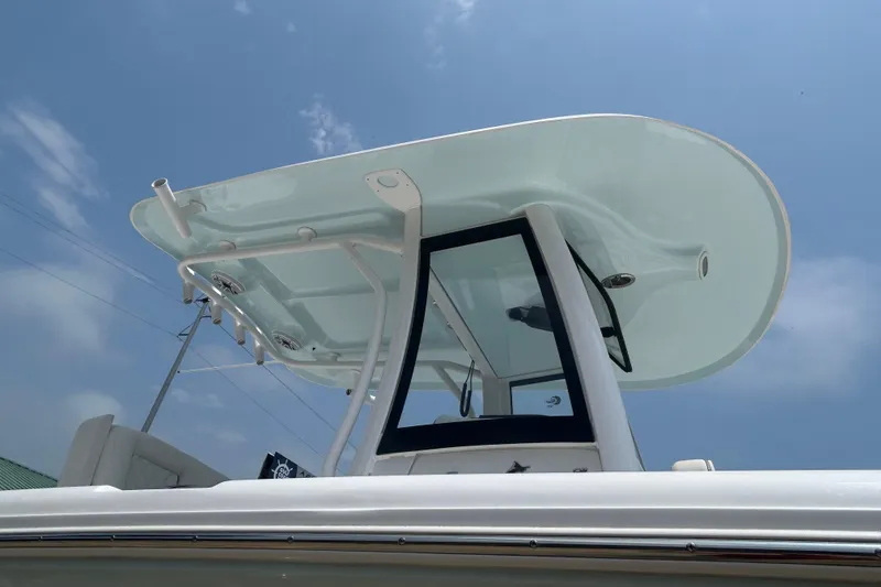 Slide: The Image of 2026 Sea Hunt Gamefish 27 Coffin Box boat, featuring sleek T-top design against blue sky. - 4