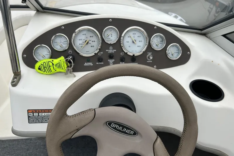 Slide: The Image of 2003 Bayliner 175 Bowrider dashboard with gauges and steering wheel. - 6