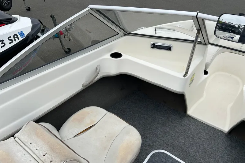 Slide: The Image of 2003 Bayliner 175 Bowrider interior with seating and dashboard view. - 7