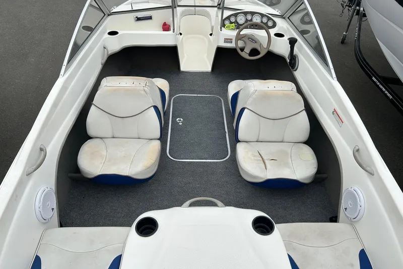 Slide: The Image of 2003 Bayliner 175 Bowrider interior with white seating and dashboard view. - 8