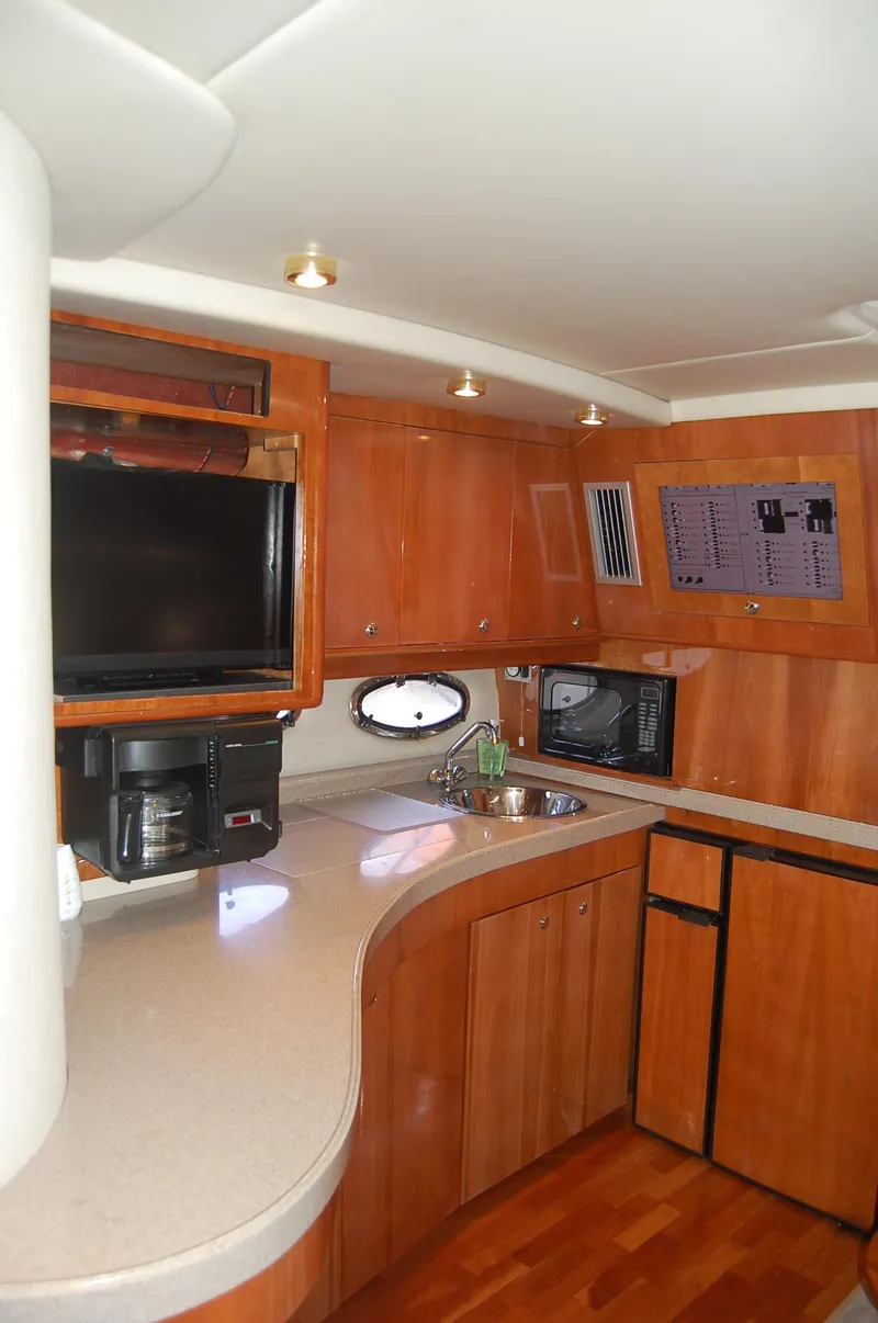 Slide: The Image of Interior of 2002 Regal Commodore 4260 yacht featuring modern kitchen. - 10