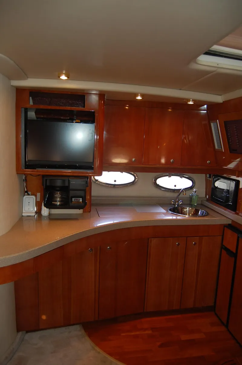 Slide: The Image of Interior of 2002 Regal Commodore 4260 yacht featuring elegant kitchen. - 11