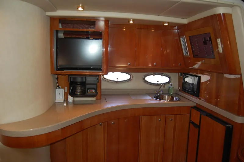 Slide: The Image of Interior of 2002 Regal Commodore 4260 yacht featuring modern kitchen. - 12
