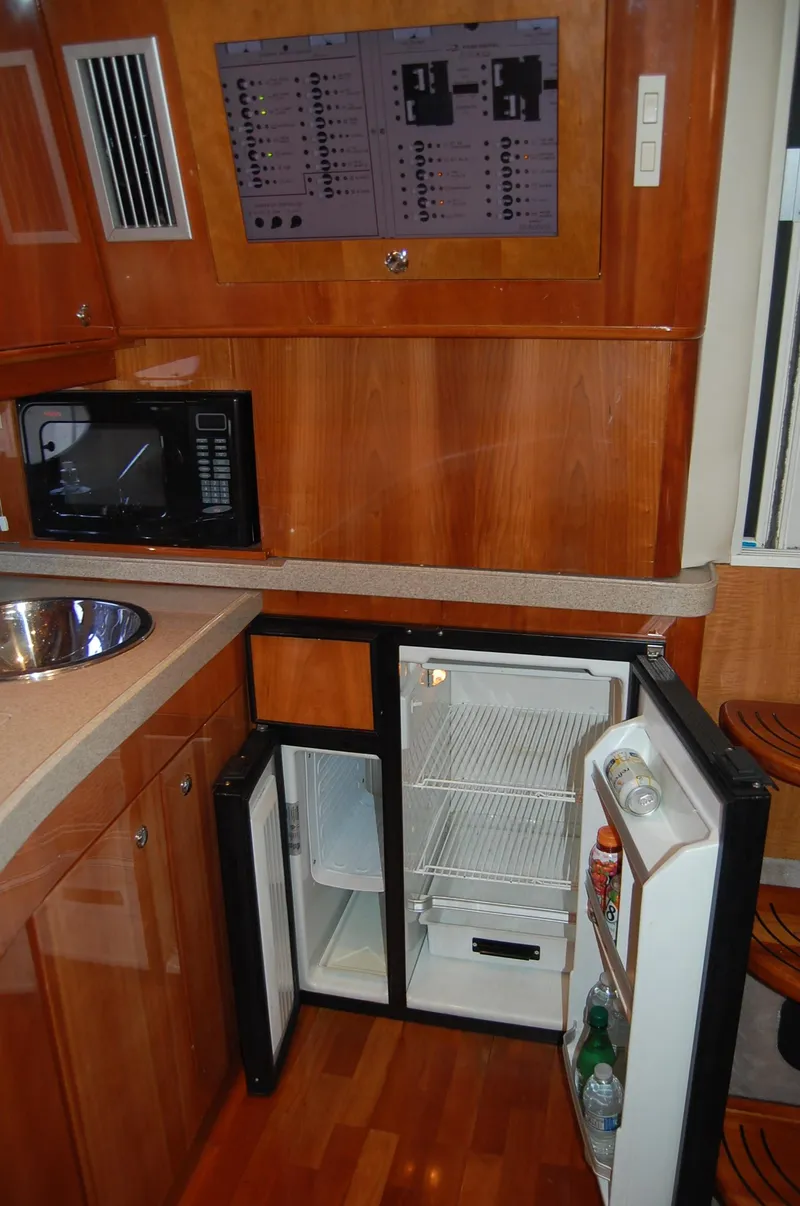 Slide: The Image of Interior of Regal Commodore 4260 yacht with fridge and microwave. - 16