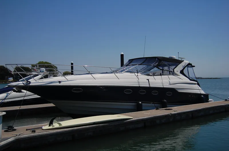 Slide: The Image of 2002 Regal Commodore 4260 yacht docked on a sunny day. - 2