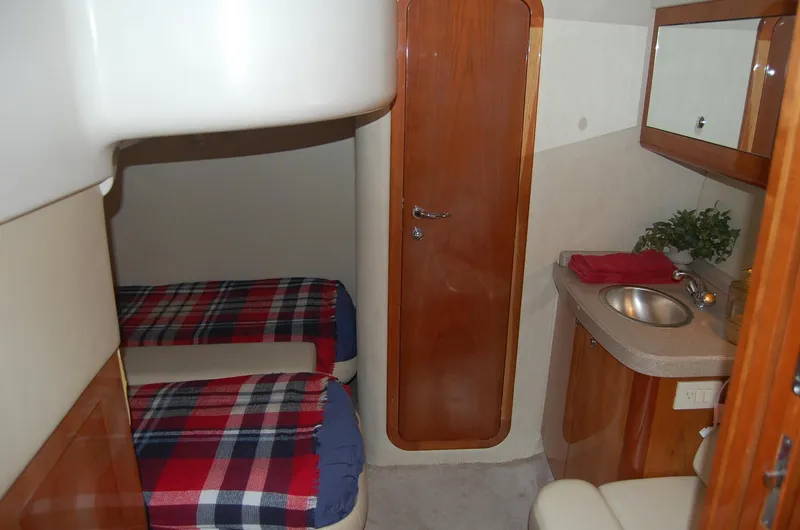 Slide: The Image of Interior of 2002 Regal Commodore 4260 yacht with sleeping area and sink. - 24