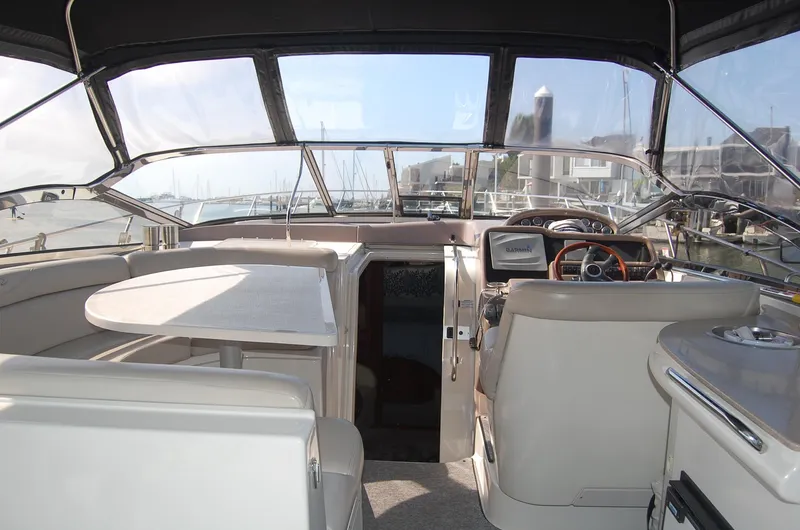 Slide: The Image of Interior of a 2002 Regal Commodore 4260 yacht, featuring helm and seating area. - 30