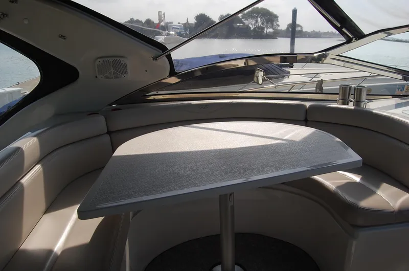 Slide: The Image of Interior of 2002 Regal Commodore 4260 boat with seating area and table. - 34