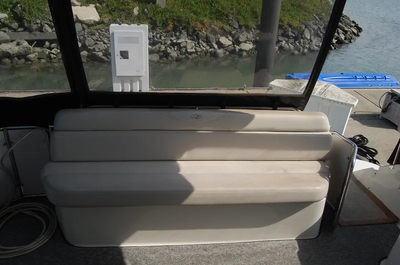 Slide: The Image of Regal Commodore 4260 boat seating, 2002 model, by the water. - 39